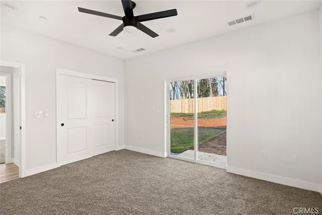 a view of a room with window and a ceiling fan