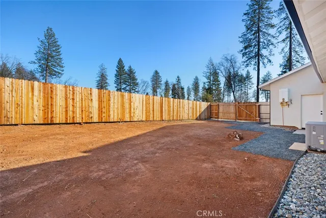 a backyard of a house with table and chairs