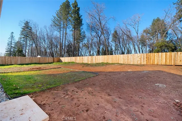 a view of backyard with large trees