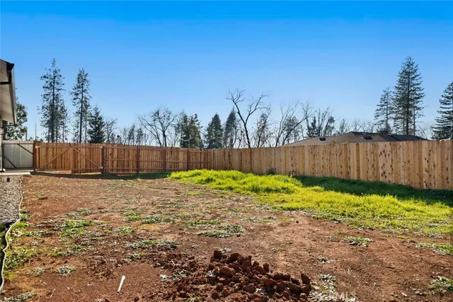 a backyard with a wooden fence