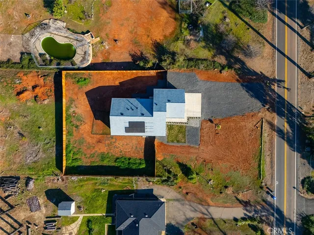 an aerial view of a house with a yard