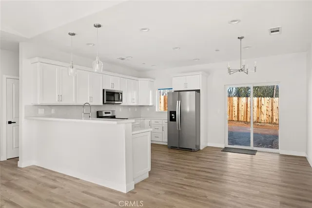 a kitchen with stainless steel appliances a refrigerator sink and cabinets
