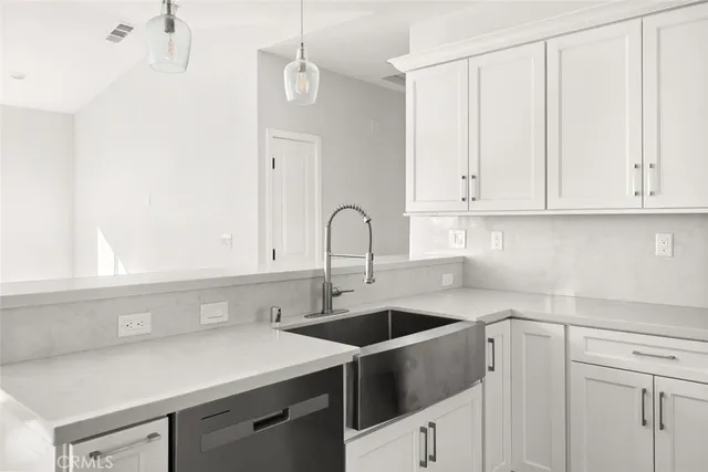 a kitchen with a sink cabinets and stainless steel appliances