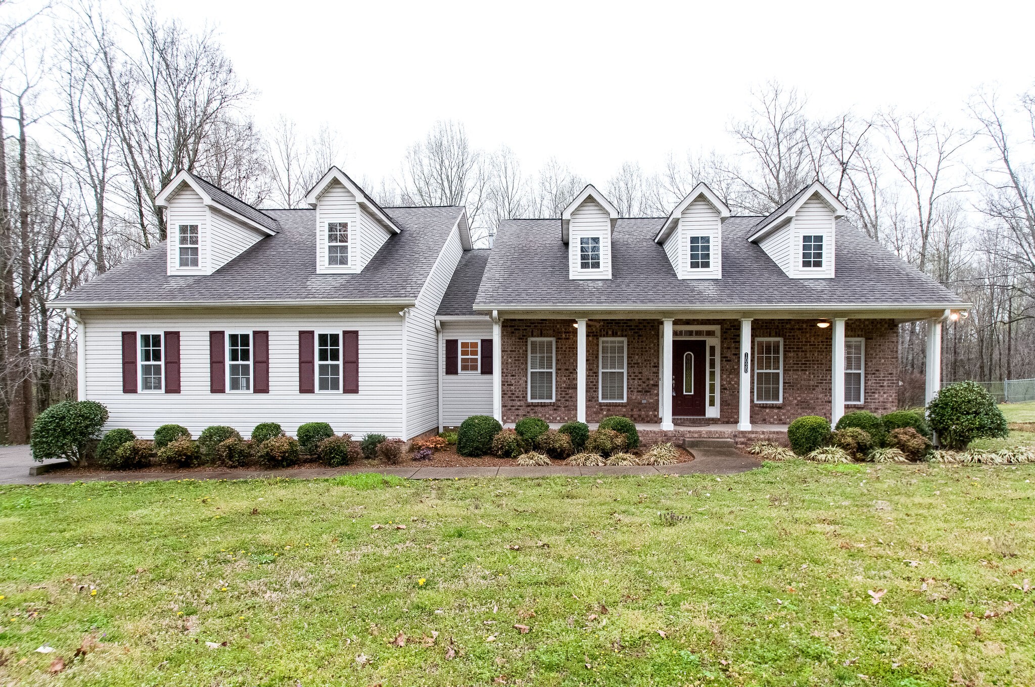 1020 Meeks Cemetery Road Burns, TN 37029 - Photo 1 of 32 a front view of a house with a garden