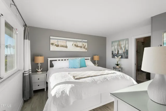 a bedroom with a bed and a lamp