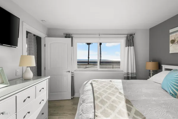 a bedroom with a bed and flat screen tv