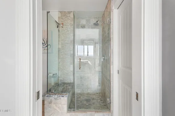a bathroom with a glass shower door