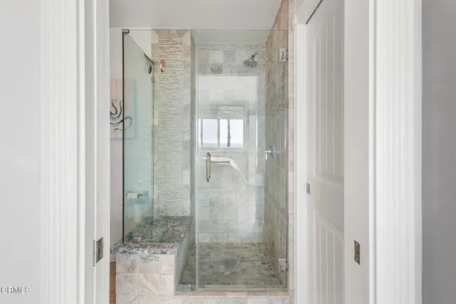 a bathroom with a glass shower door