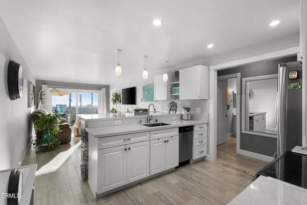 a kitchen with stainless steel appliances kitchen island granite countertop a sink and cabinets