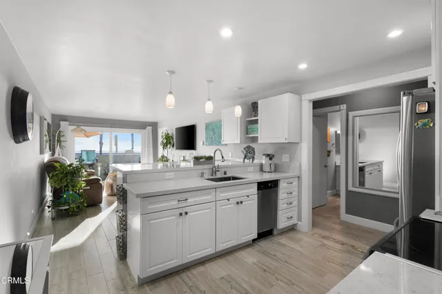 a kitchen with stainless steel appliances kitchen island granite countertop a sink and cabinets