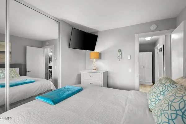 a bedroom with a bed and a flat screen tv