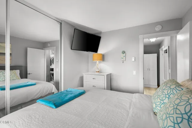 a bedroom with a bed and a flat screen tv