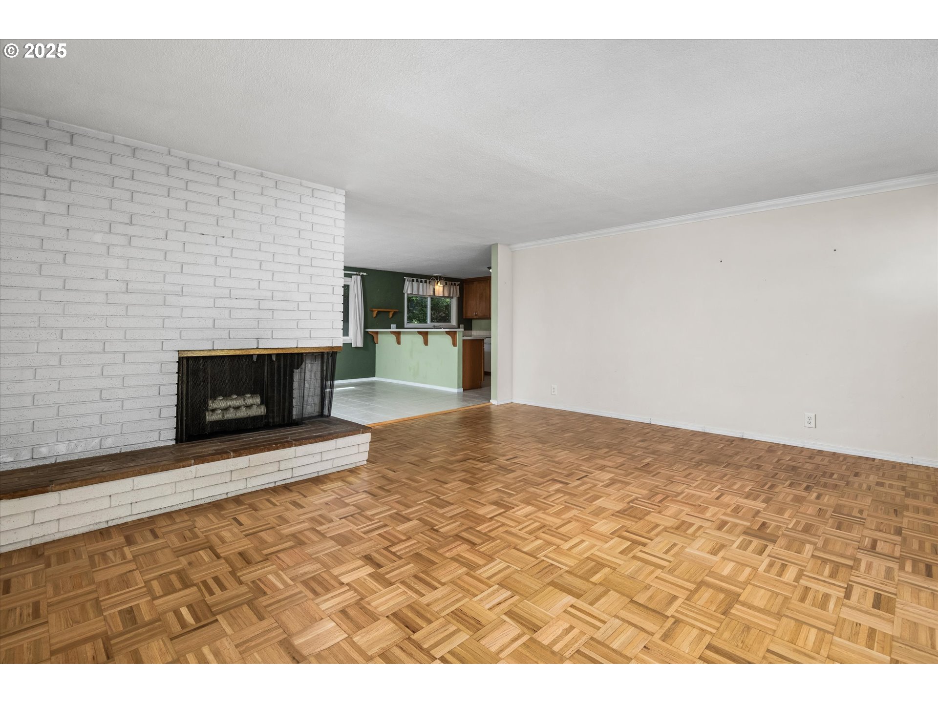 3985 Donald Street Eugene, OR 97405 - Photo 11 of 39 a view of empty room with wooden floor and fireplace