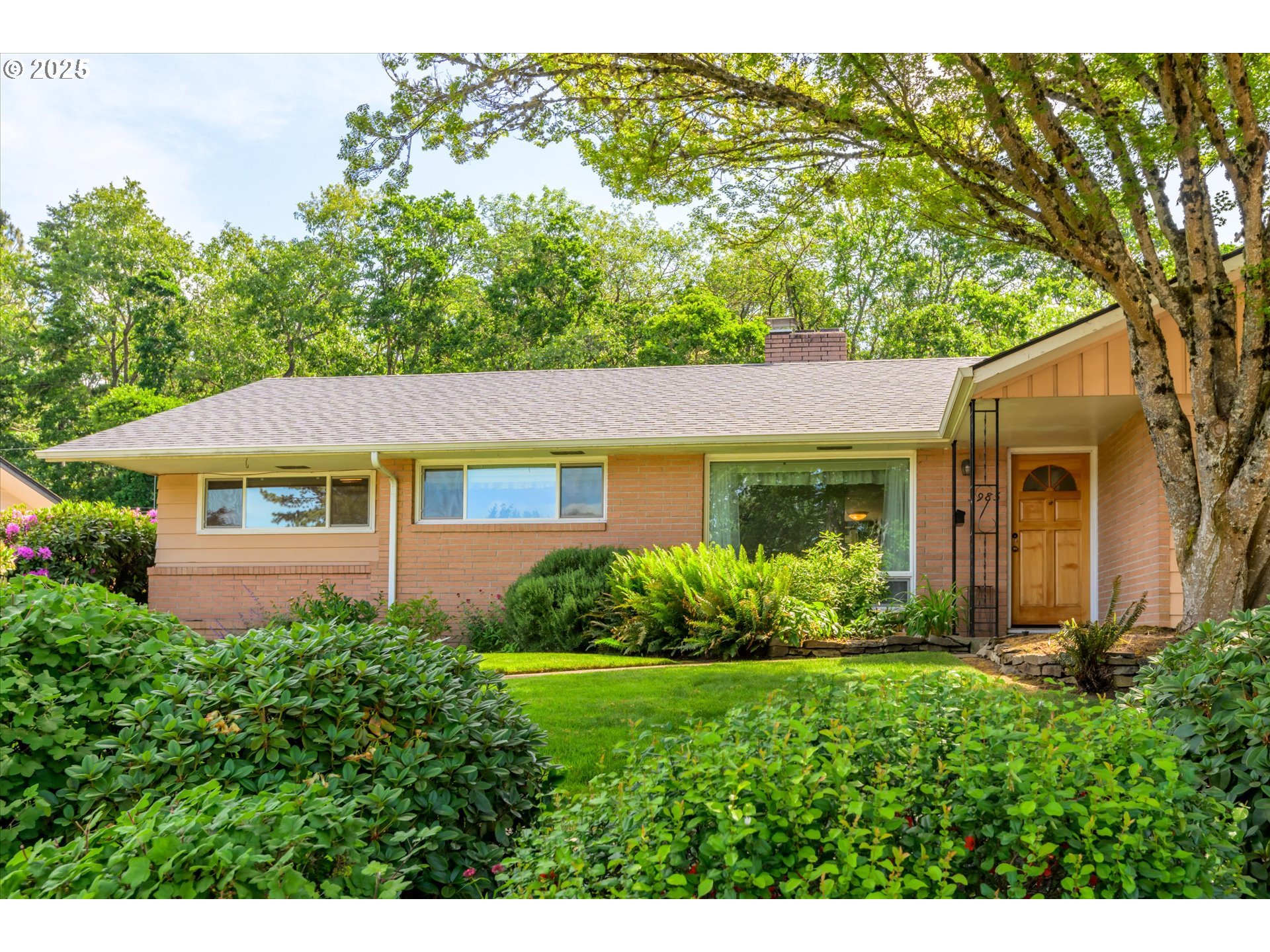 3985 Donald Street Eugene, OR 97405 - Photo 3 of 39 a front view of a house with garden