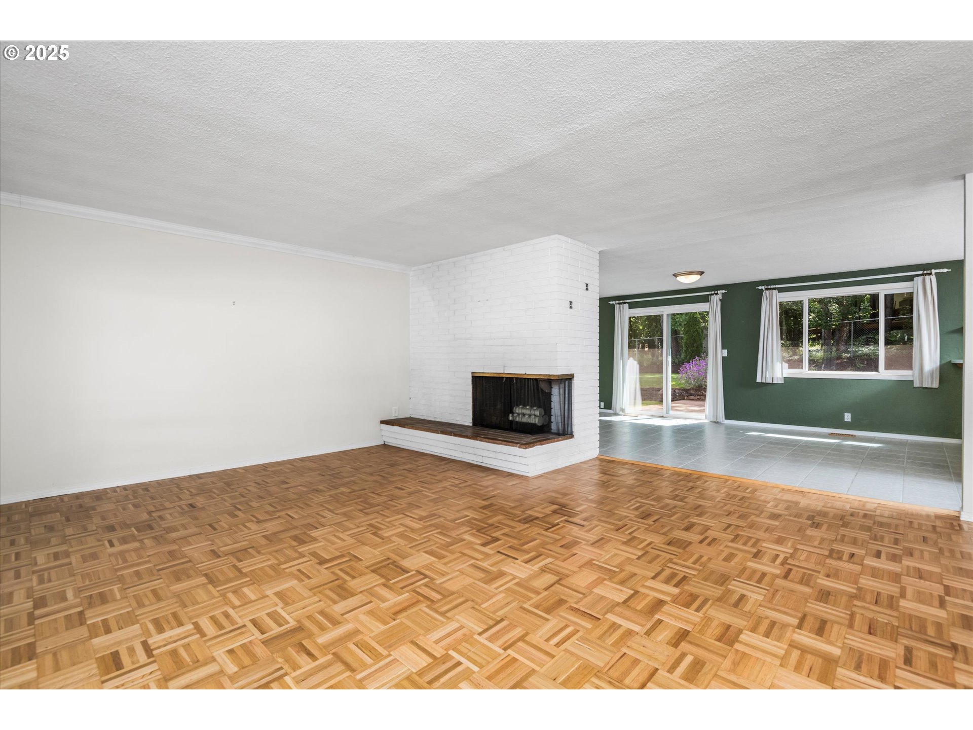 3985 Donald Street Eugene, OR 97405 - Photo 9 of 39 a view of empty room with wooden floor and fireplace