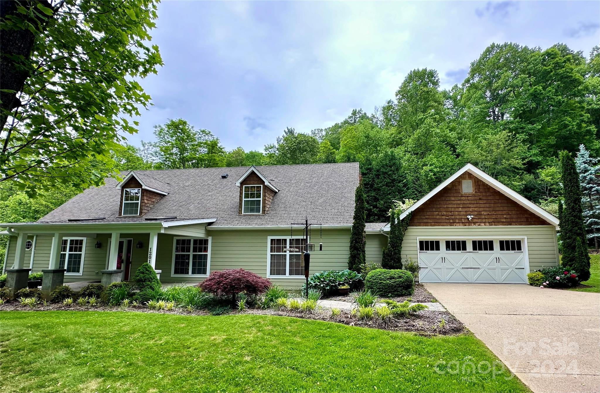 1201 Camp Branch Road Waynesville, NC 28786 - Photo 1 of 26 a front view of a house with a yard and porch