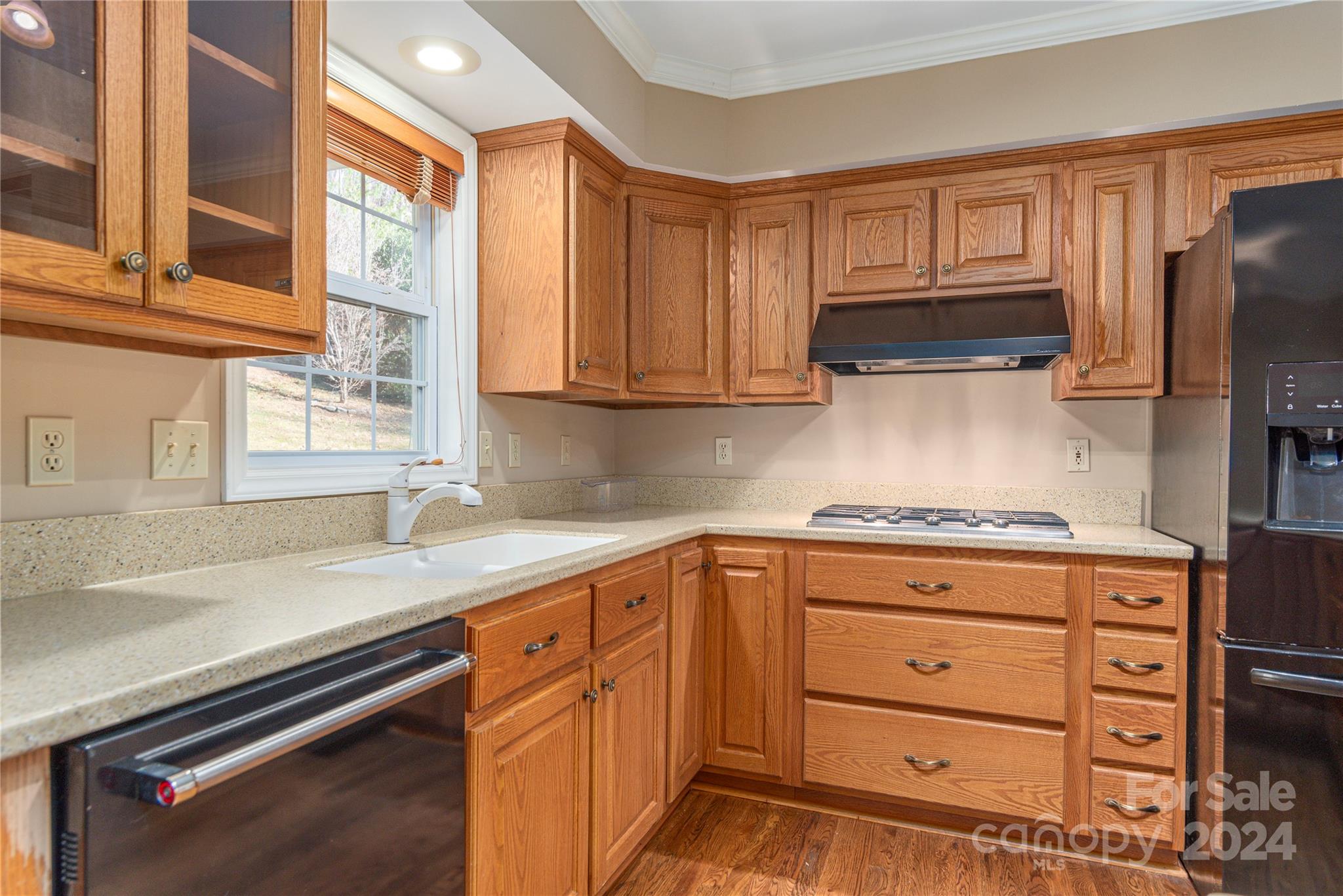 1201 Camp Branch Road Waynesville, NC 28786 - Photo 13 of 26 a kitchen with granite countertop a sink cabinets stainless steel appliances and a window