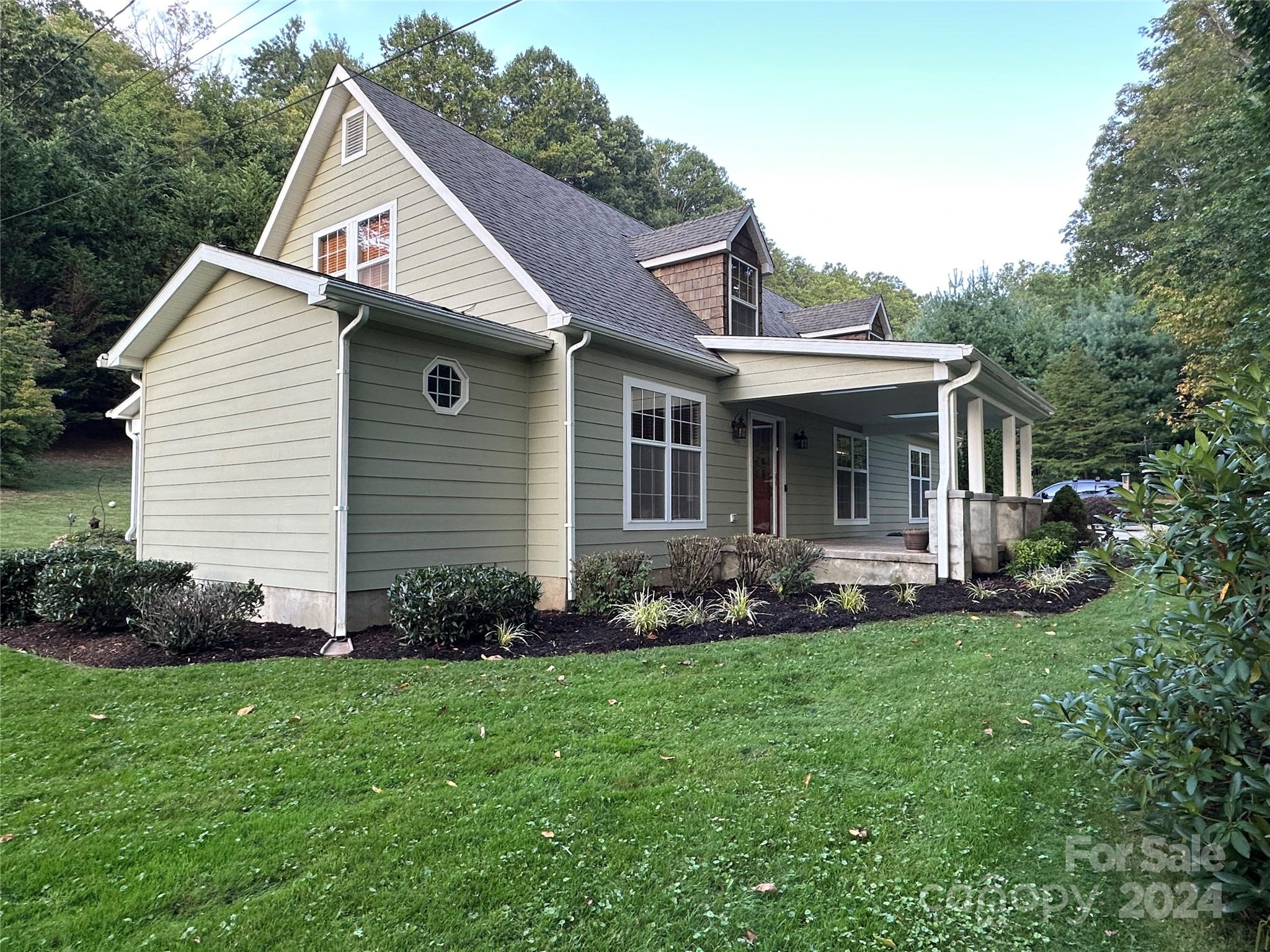 1201 Camp Branch Road Waynesville, NC 28786 - Photo 3 of 26 a view of a house with a yard and garden