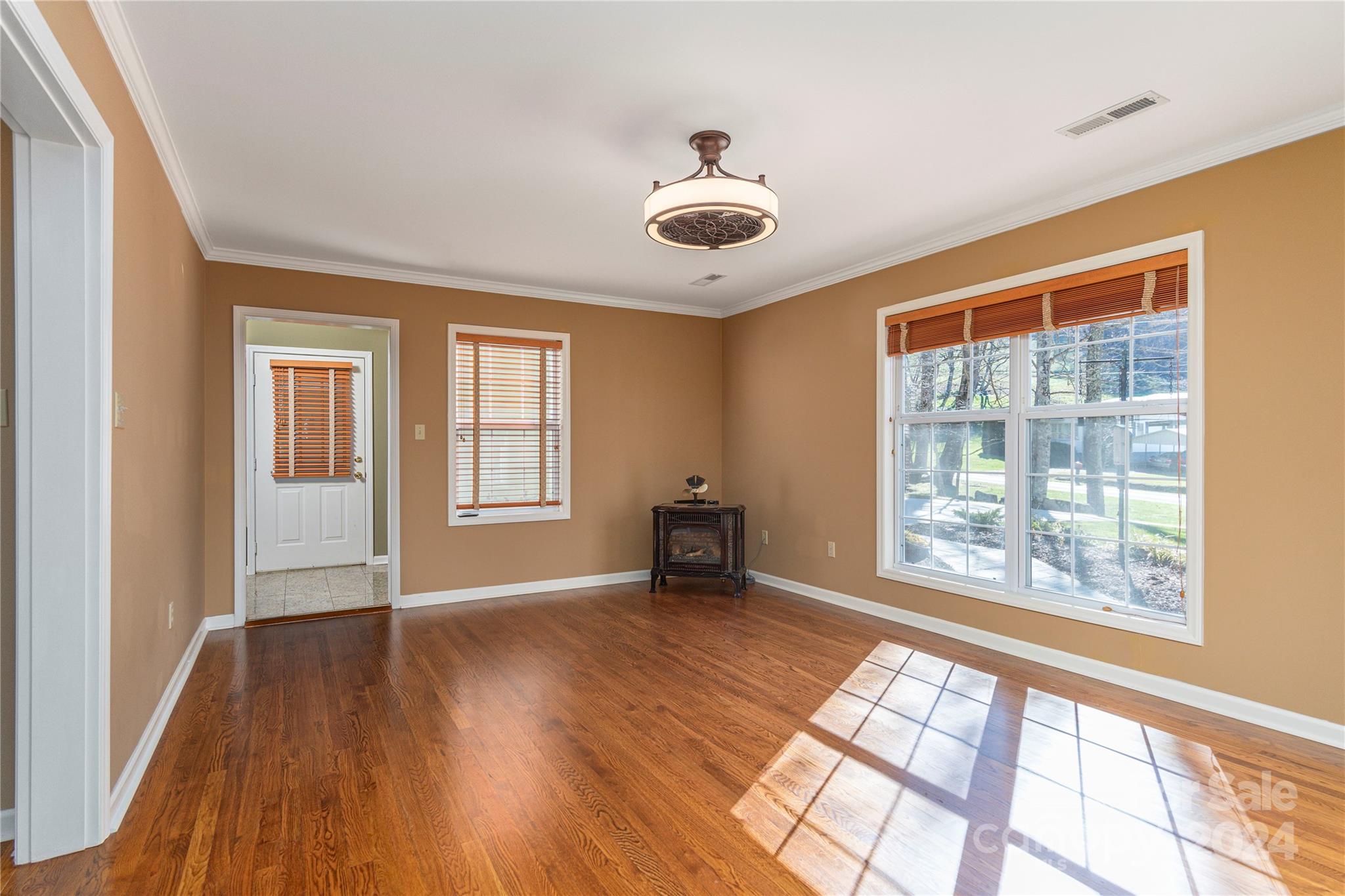 1201 Camp Branch Road Waynesville, NC 28786 - Photo 5 of 26 a view of an empty room with a window and wooden floor