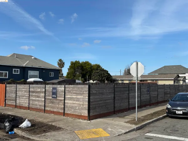a view of a house with wooden fence
