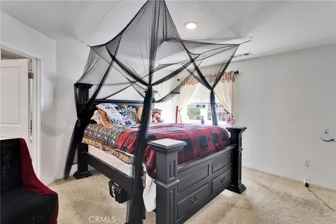 a bed room with a bed and a window