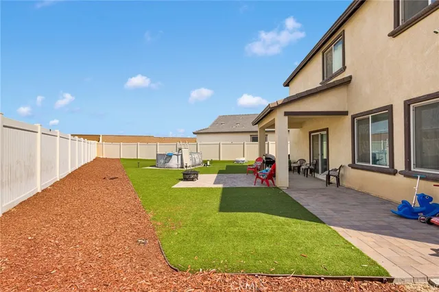 a view of a house with swimming pool and sitting area