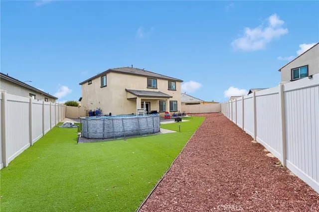 a view of a house with a yard and pathway