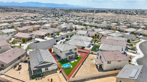 an aerial view of a residential houses with yard