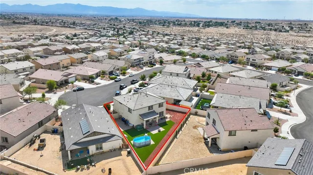 an aerial view of a residential houses with yard