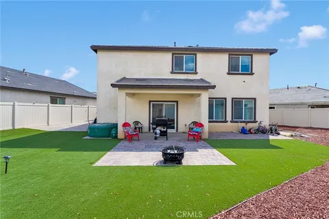 a group of people sitting in front of a house