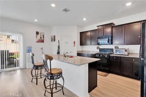 a kitchen with stainless steel appliances kitchen island granite countertop a sink and cabinets