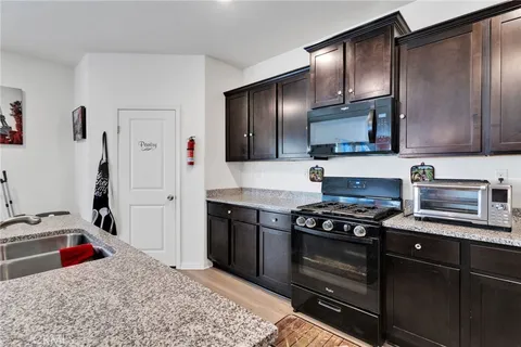 a kitchen with stainless steel appliances granite countertop a stove and a sink