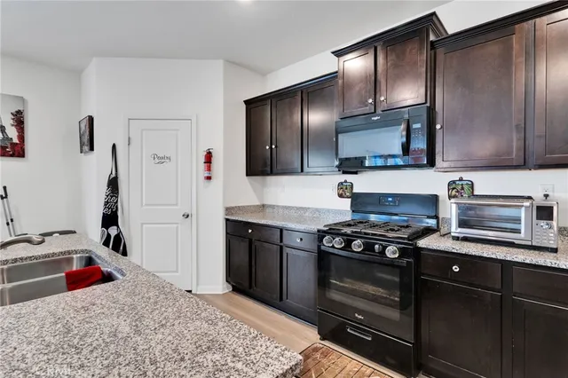a kitchen with stainless steel appliances granite countertop a stove and a sink