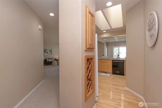a view of a hallway with a livingroom and a bathroom