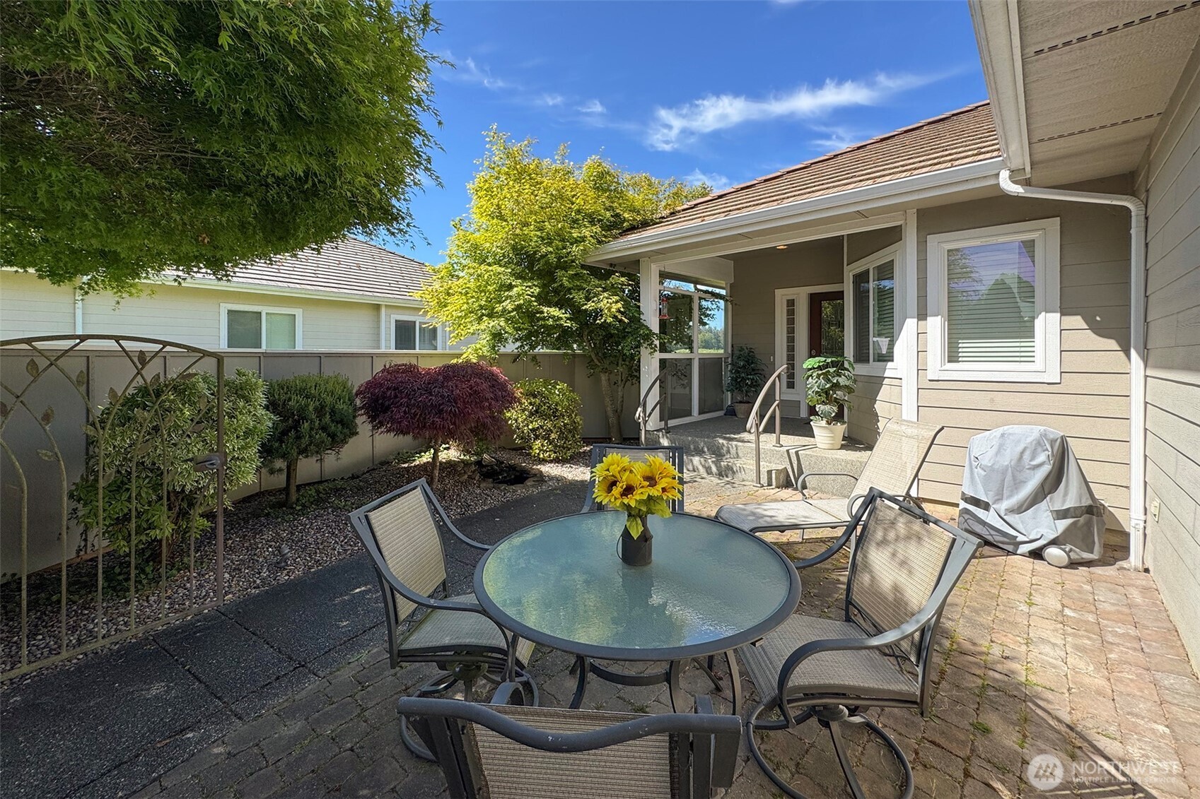 40 Cascadia Loop Sequim, WA 98382 - Photo 5 of 40 a view of a patio with table and chairs potted plants and a large tree