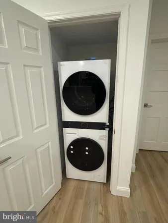 a close up view of a hallway with washer and dryer