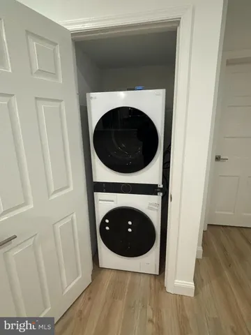 a close up view of a hallway with washer and dryer
