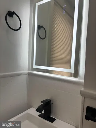 a bathroom with a sink and a window