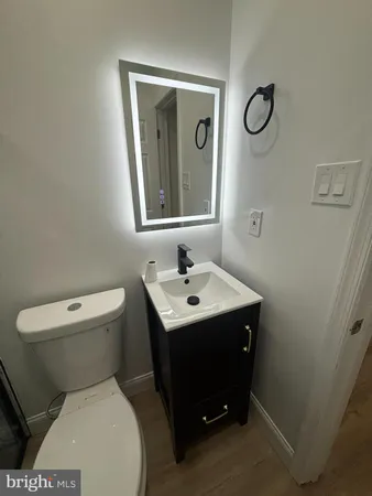 a bathroom with a toilet sink and mirror