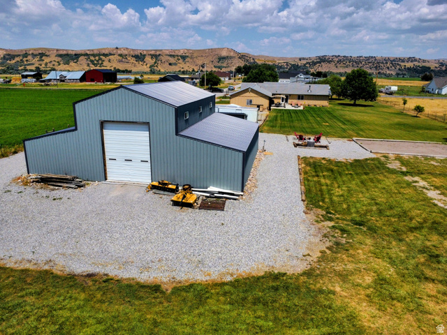 802 East 3200 Road North Preston, ID 83263 - Photo 54 of 59 Multi-structure property featuring a large gray metal building with a white overhead door and a separate residence