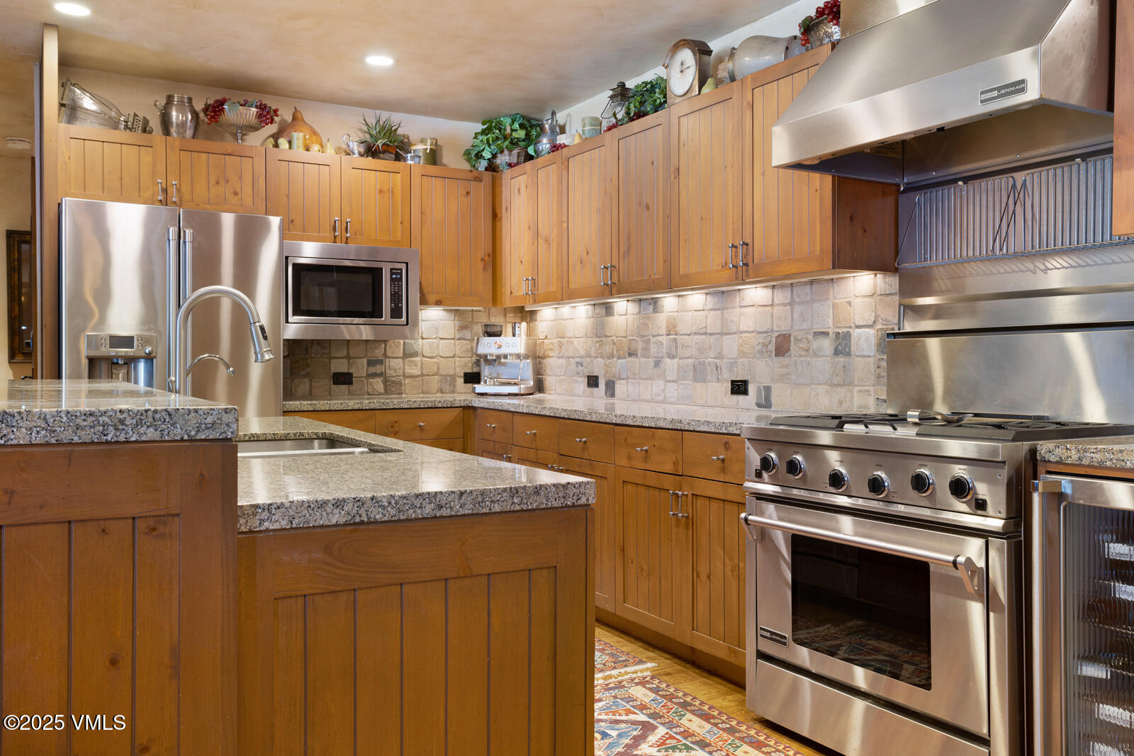 180 Daybreak Ridge Road, Unit 410 Avon, CO 81620 - Photo 11 of 30 a kitchen with stainless steel appliances granite countertop a stove a sink dishwasher and a refrigerator