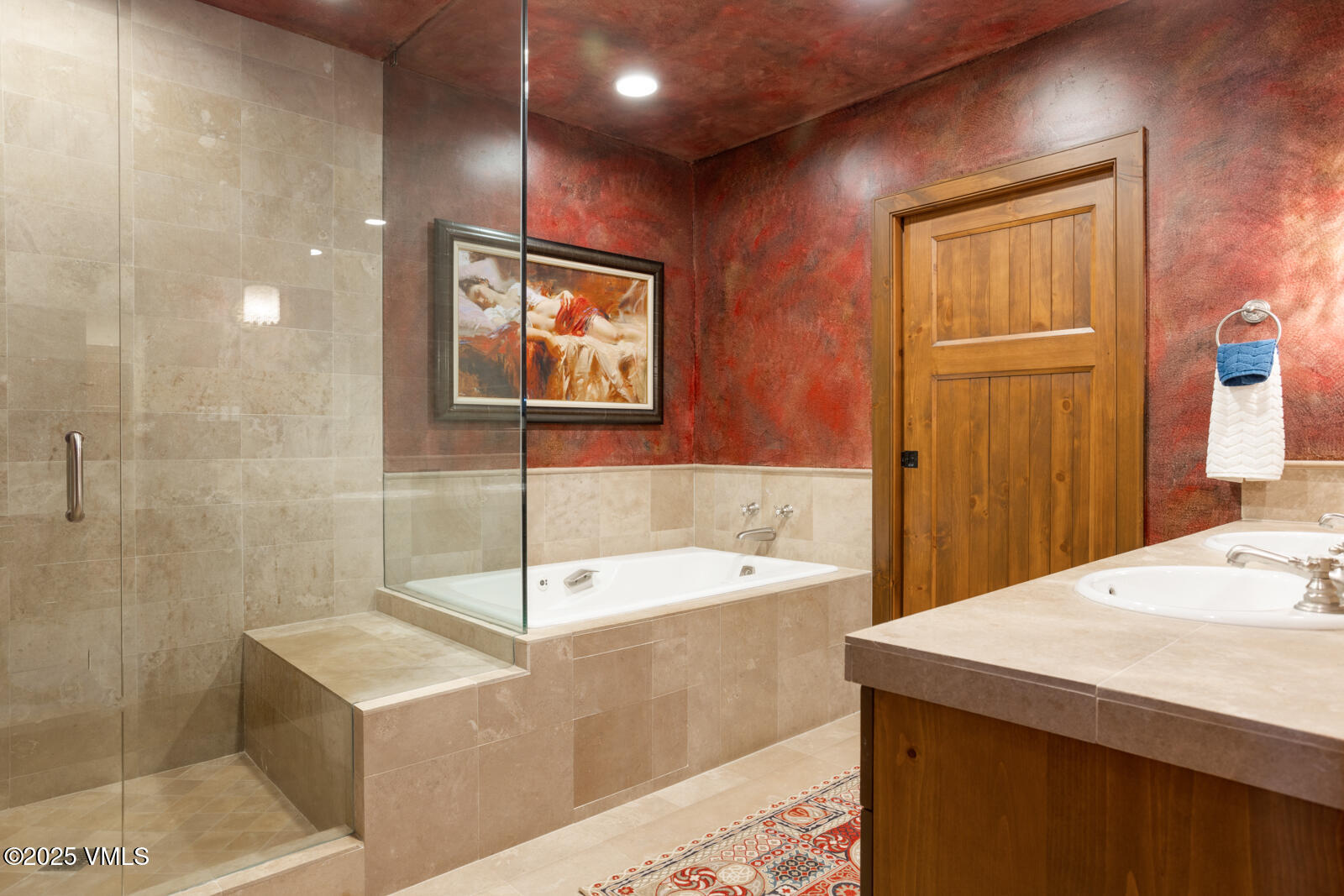 180 Daybreak Ridge Road, Unit 410 Avon, CO 81620 - Photo 16 of 30 a bathroom with a tub sink and mirror