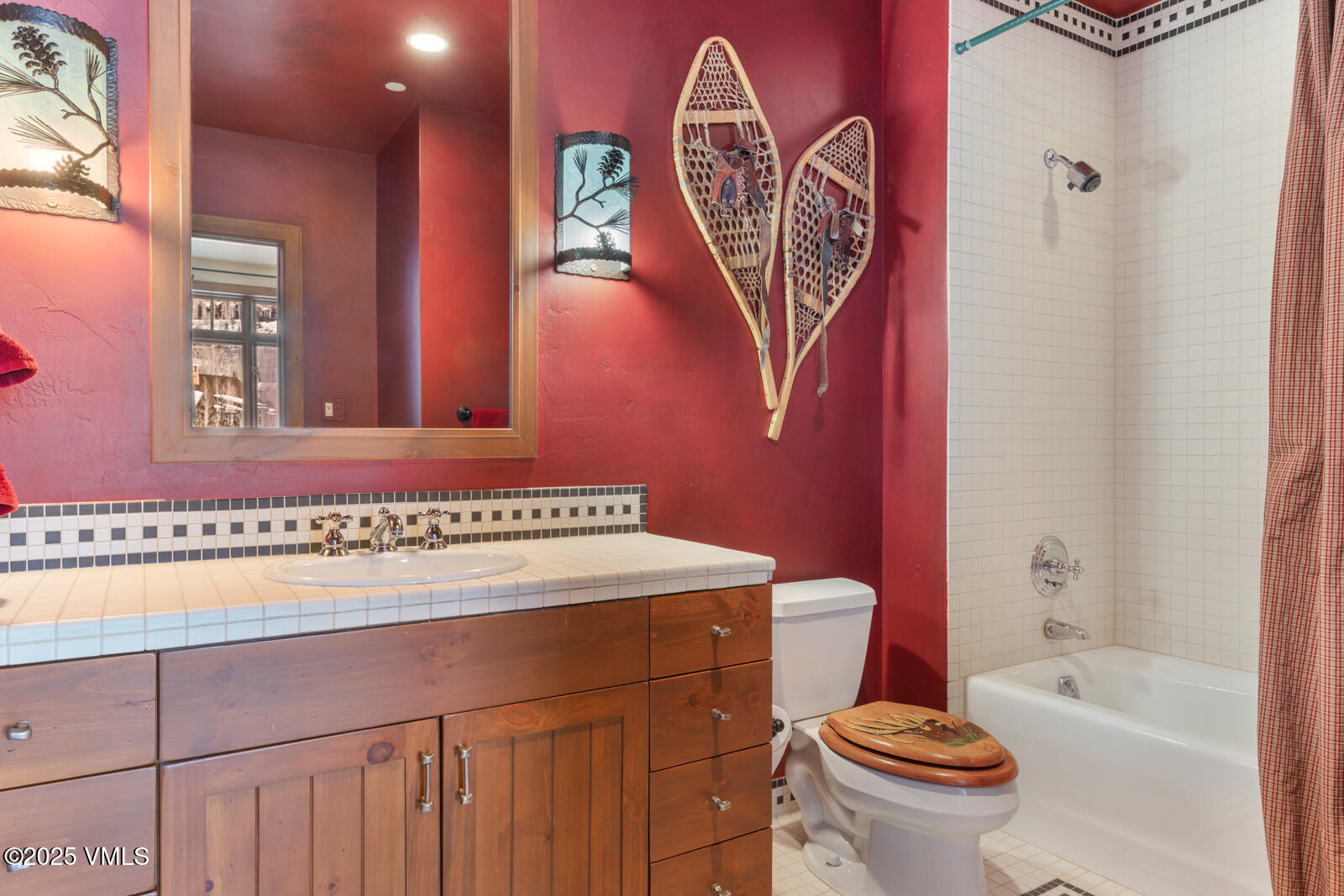 180 Daybreak Ridge Road, Unit 410 Avon, CO 81620 - Photo 23 of 30 a bathroom with a toilet a sink and a bathtub