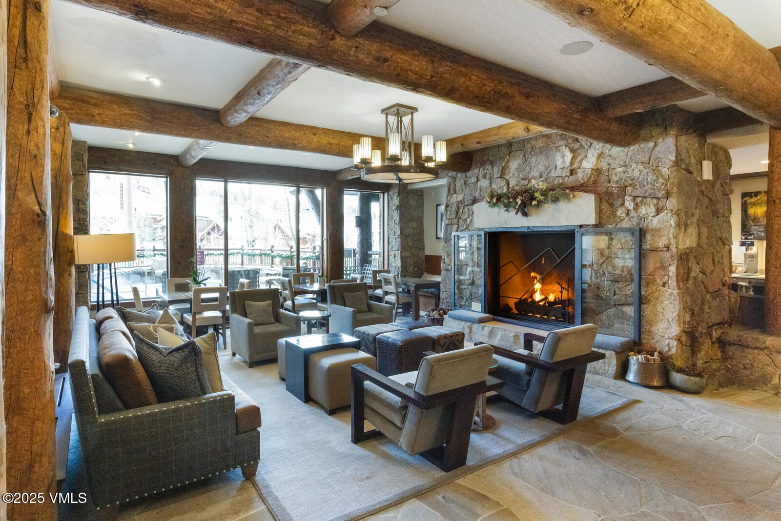 180 Daybreak Ridge Road, Unit 410 Avon, CO 81620 - Photo 26 of 30 a living room with fireplace furniture and a flat screen tv