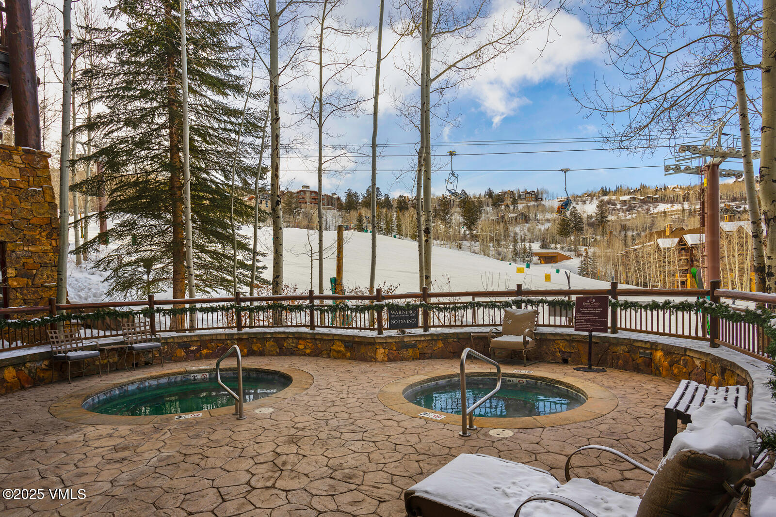 180 Daybreak Ridge Road, Unit 410 Avon, CO 81620 - Photo 27 of 30 a swimming pool with outdoor seating