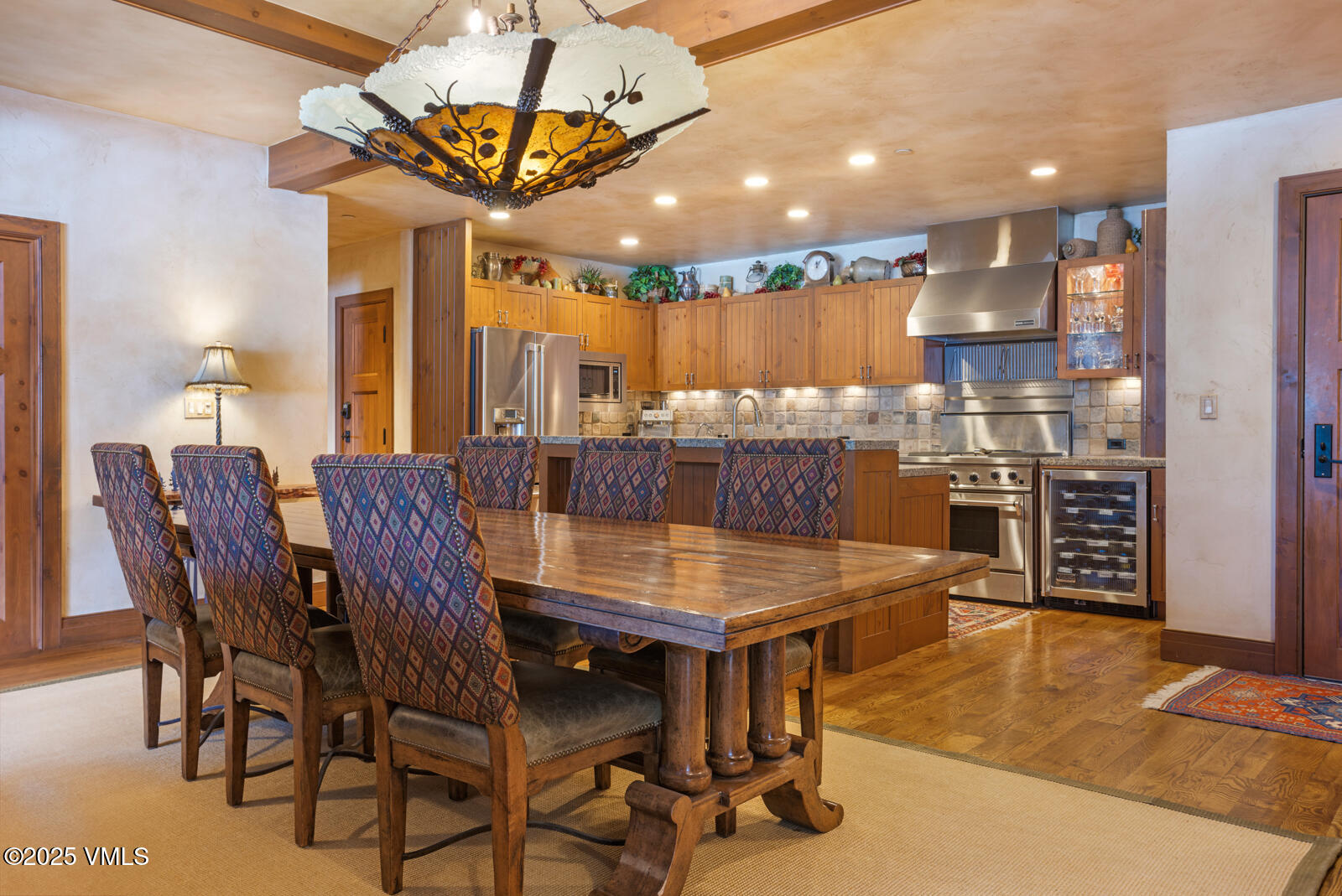 180 Daybreak Ridge Road, Unit 410 Avon, CO 81620 - Photo 9 of 30 a dining room with a table chairs and a kitchen view
