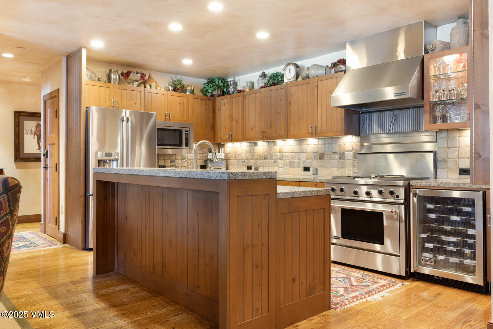 180 Daybreak Ridge Road, Unit 410 Avon, CO 81620 - Photo 10 of 30 a kitchen with stainless steel appliances granite countertop a refrigerator a stove and a sink with wooden cabinets
