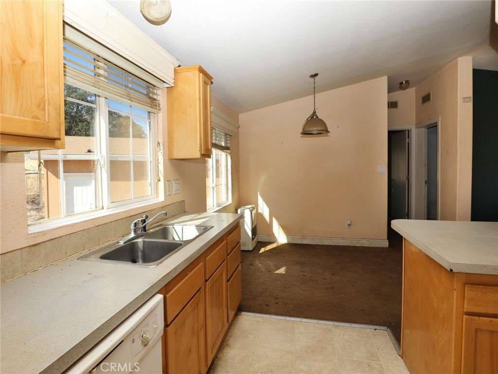 9520 Rocky Creek Road Lower Lake, CA 95457 - Photo 32 of 40 a kitchen with a sink and refrigerator