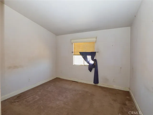 a view of a kitchen with refrigerator and cabinet
