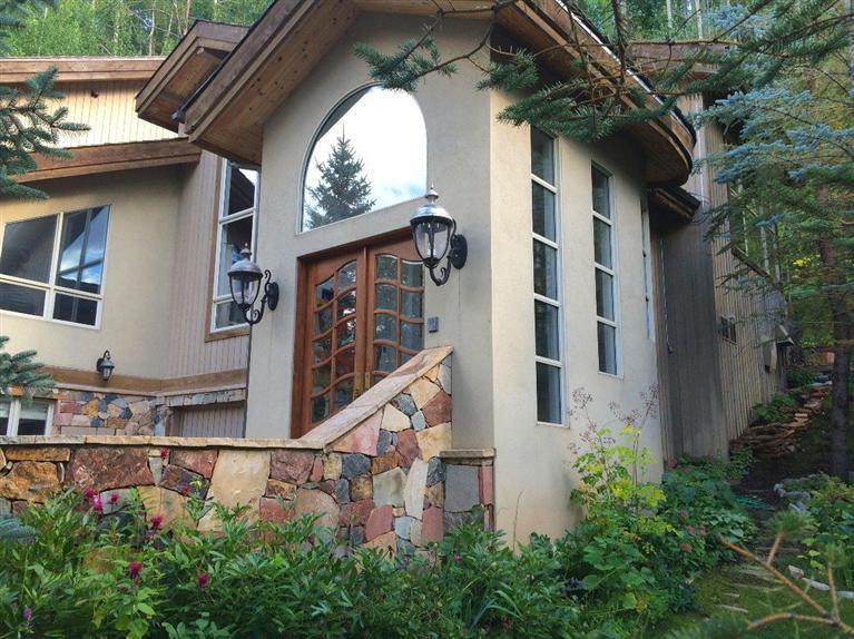716 West Forest Road, Unit B Vail, CO 81657 - Photo 3 of 8 a view of brick house with a large windows and flower plants